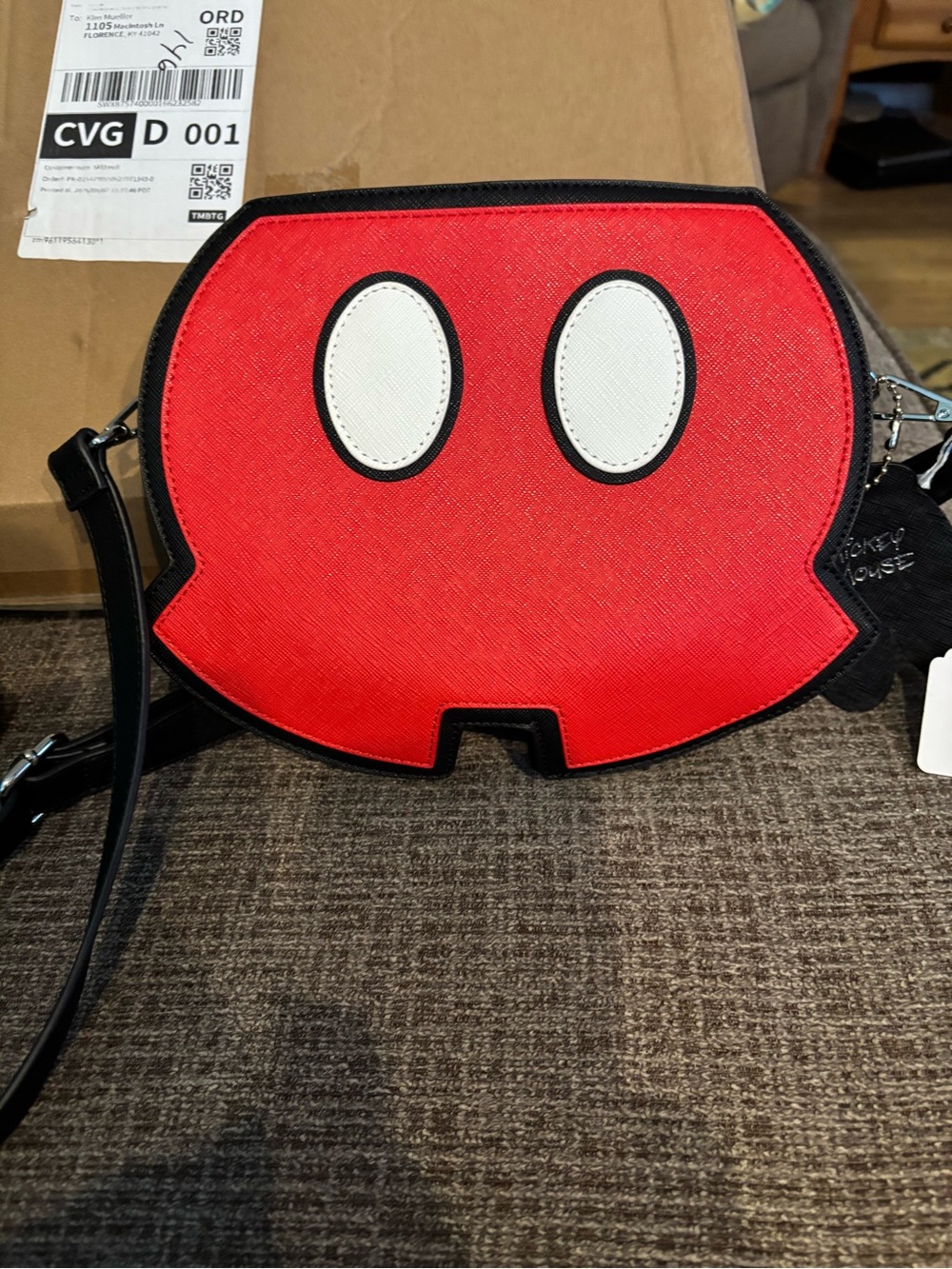 Mickey Mouse shorts crossbody bag with hangtag of white hand.